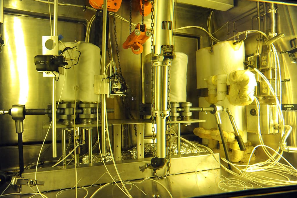 Close-up of stainless steel pipe weld joint in a coastal chemical processing plant, showing no visible pitting or staining.