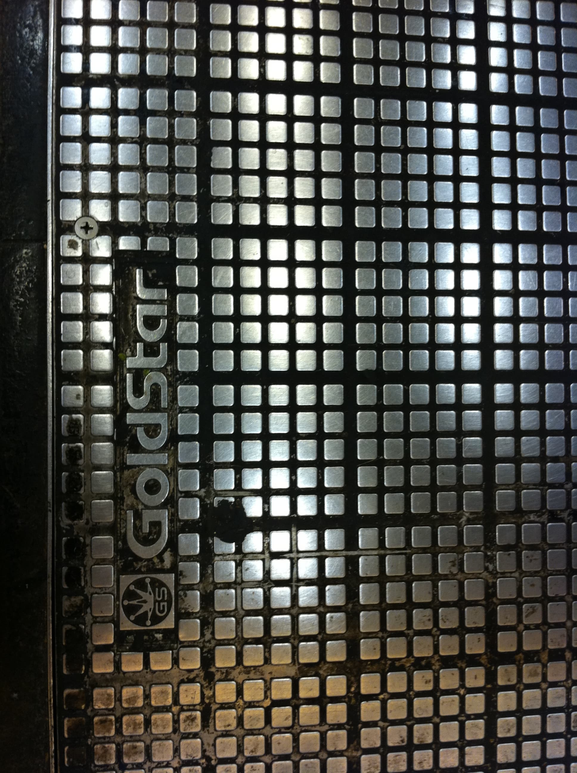 Close-up of stainless steel pipe showing uniform passive layer with no pitting or rust in an industrial water treatment setting