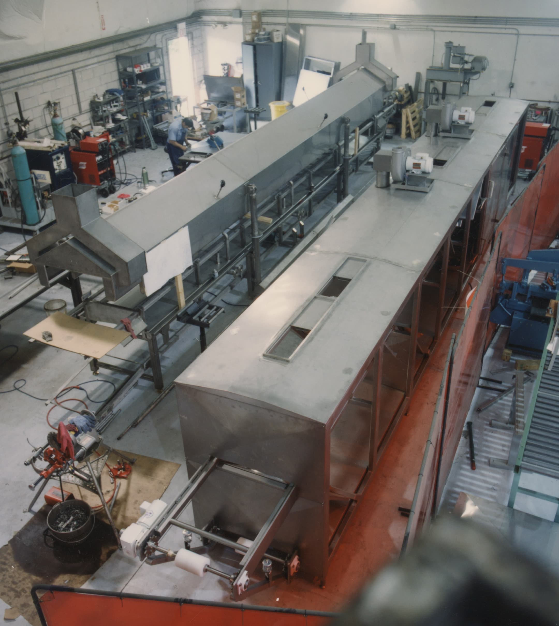 Industrial furnace with stainless steel components undergoing annealing, showing temperature-controlled heating zone and cooling section.