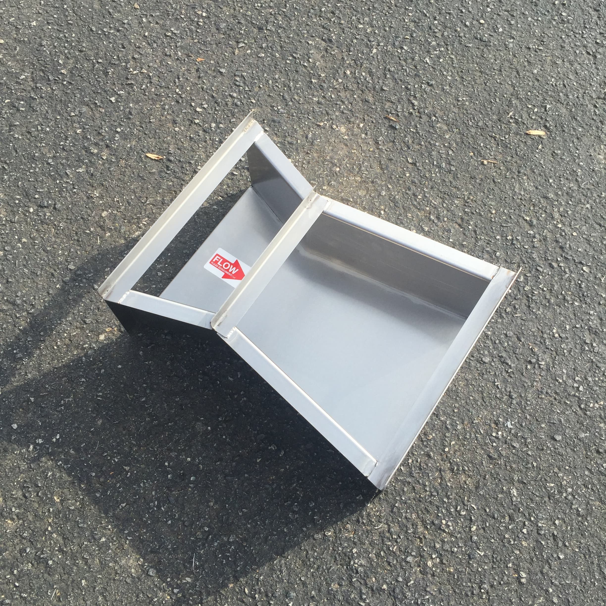 CNC lathe machining a stainless steel shaft with visible coolant flow and chip formation