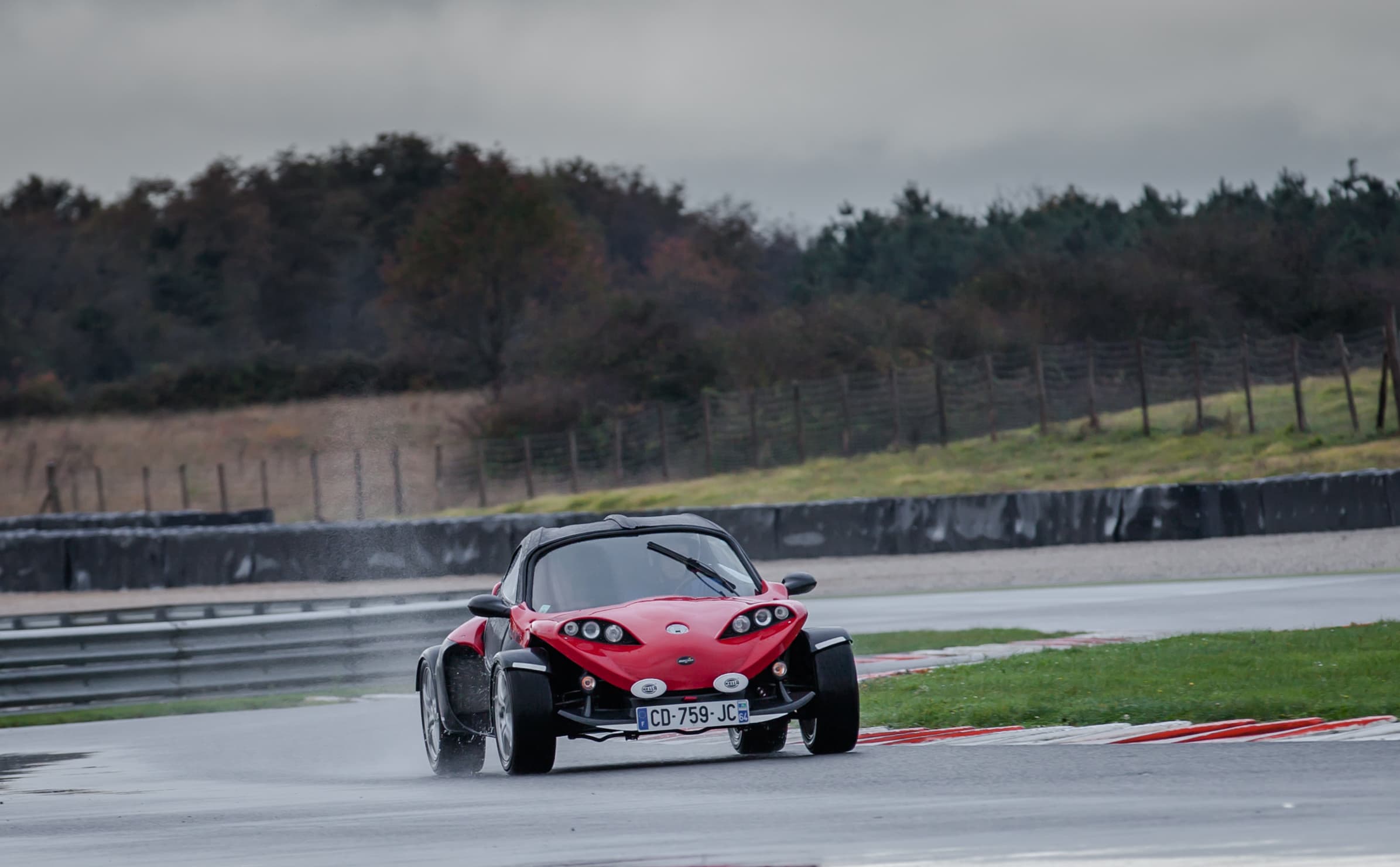 Industrial warehouse aisle with labeled stainless steel bars, sheets, and tubes stacked on pallets